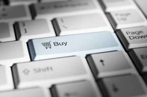 Close-up of a keyboard with a highlighted Buy button symbolizing online shopping.
